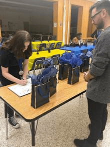  Students receiving their National Junior Honor Society Induction medals and signing the oath book at Parma Community NJHS ceremony.